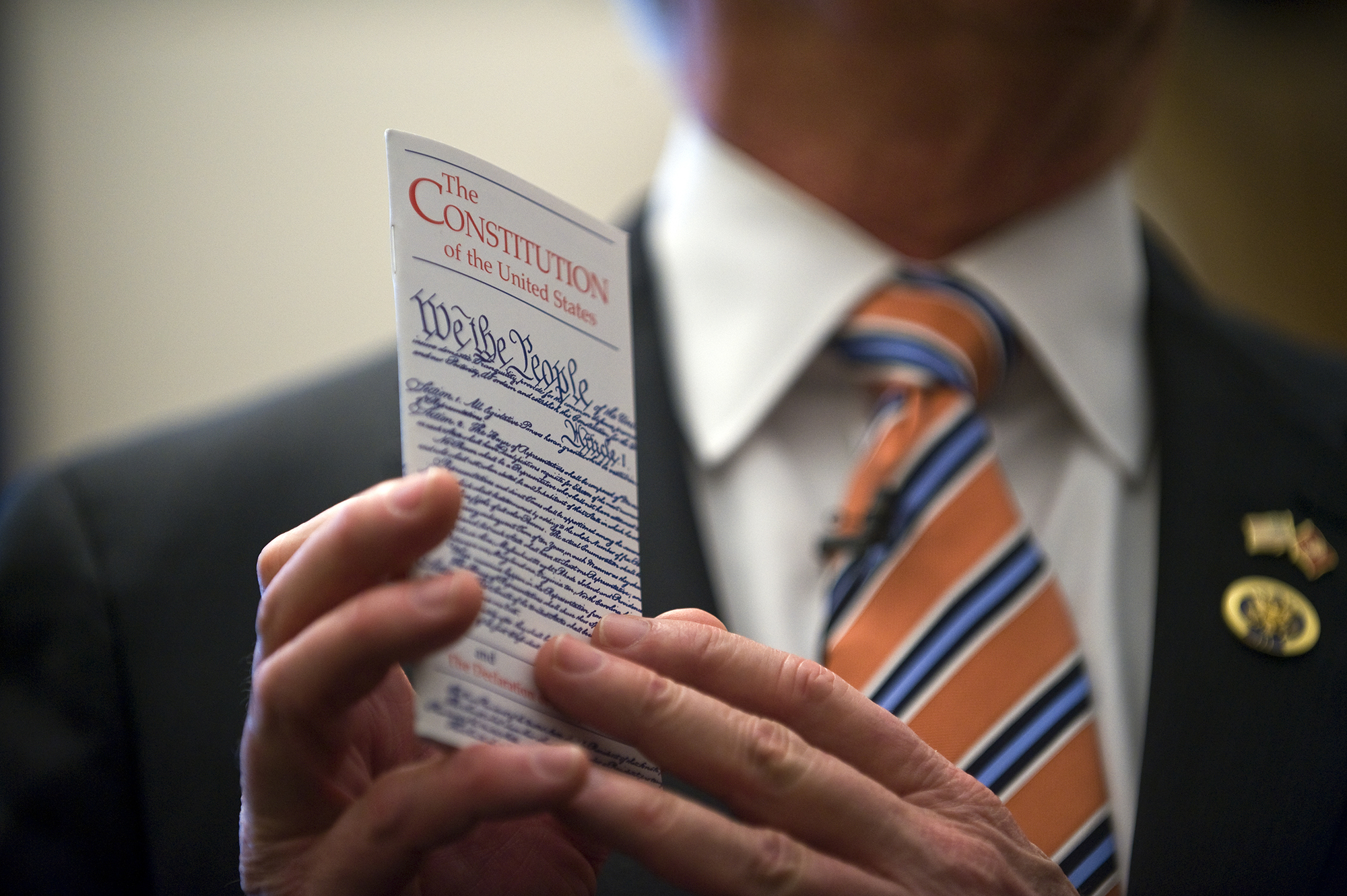 A person holding a pocket Constitution.