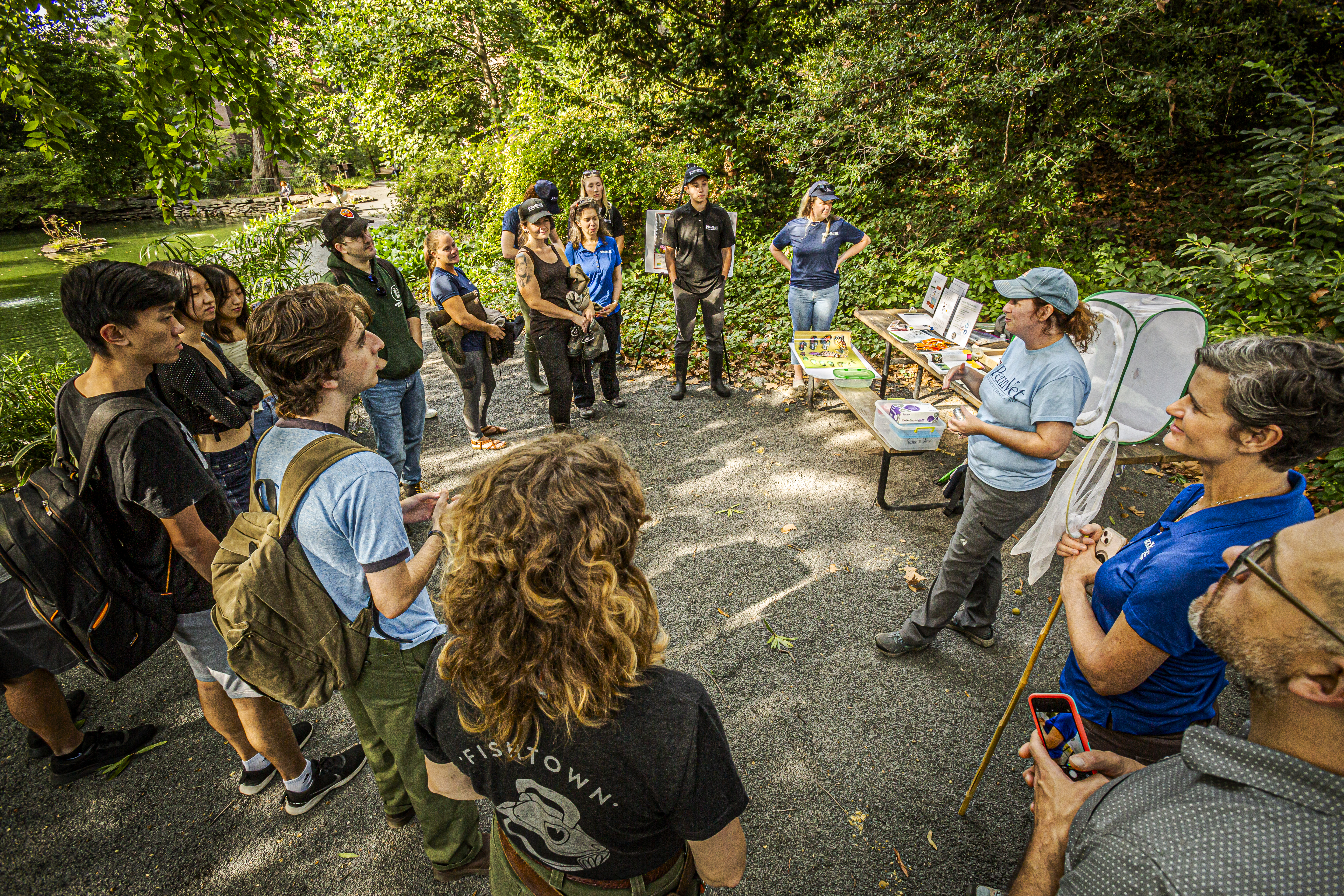 People gathered on a walking path for a climate-related lecture.