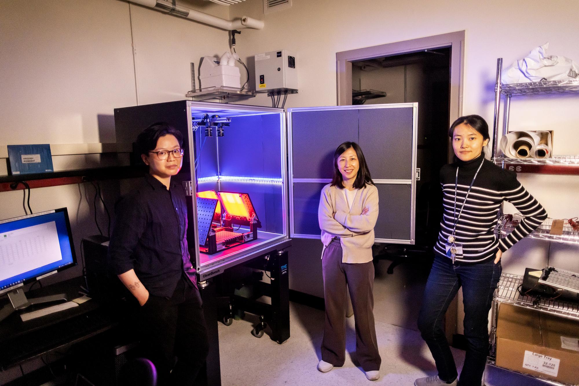 Dawn Chen, Yun Ding, and Minhao Li stand next to a recording device.