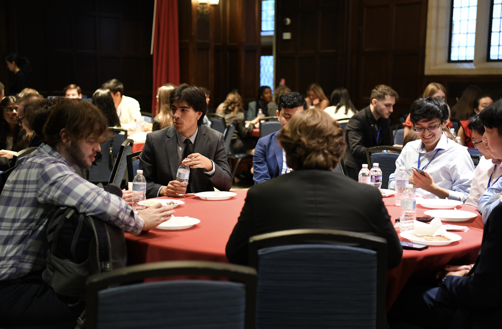 Undergraduate students sit around a round table.