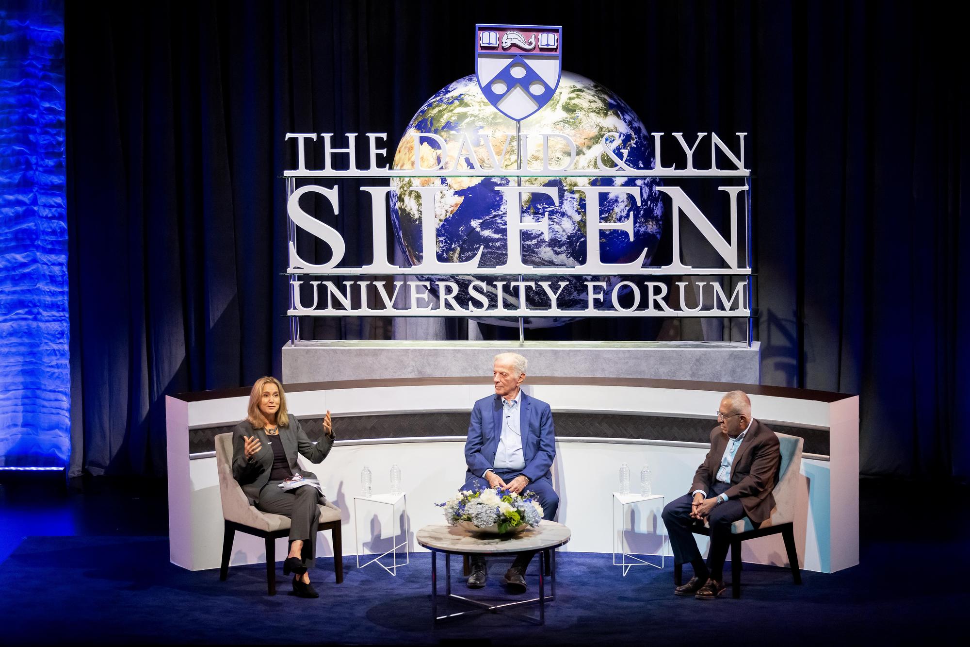 Three people seated on stage at Penn’s Silfen Forum.