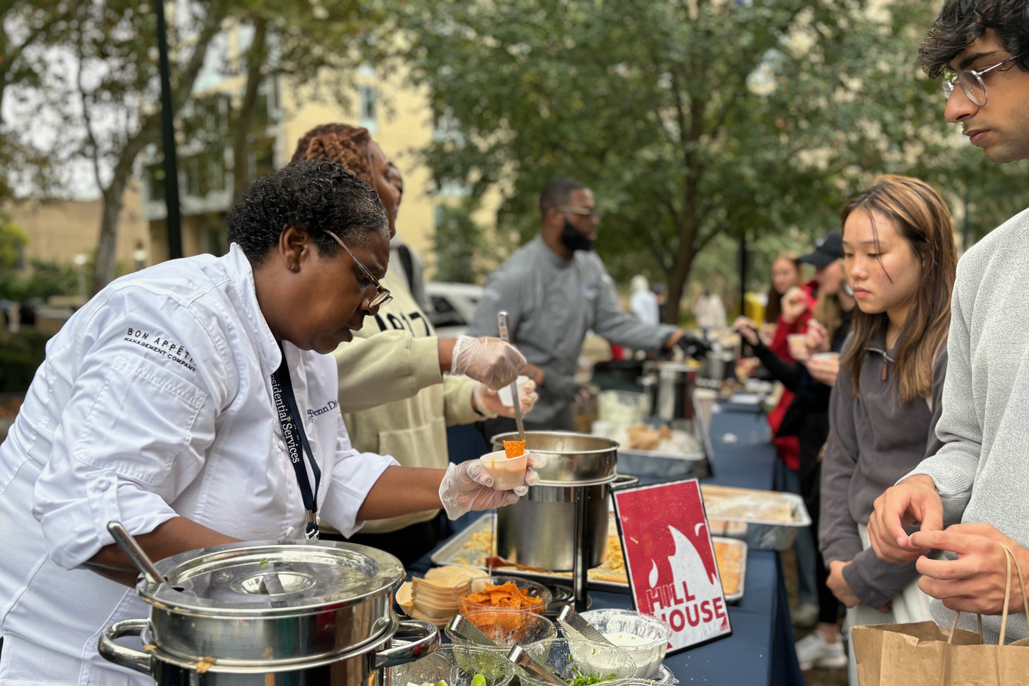 A Bon Appetit staffer hands out chili samples to Penn students.