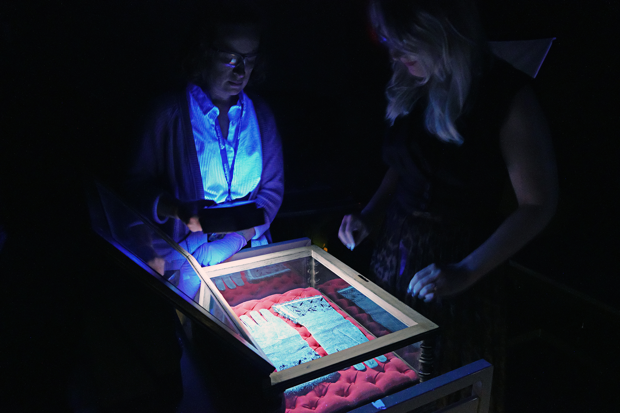 Two researchers preparing to scan historic gloves for carbon dating.