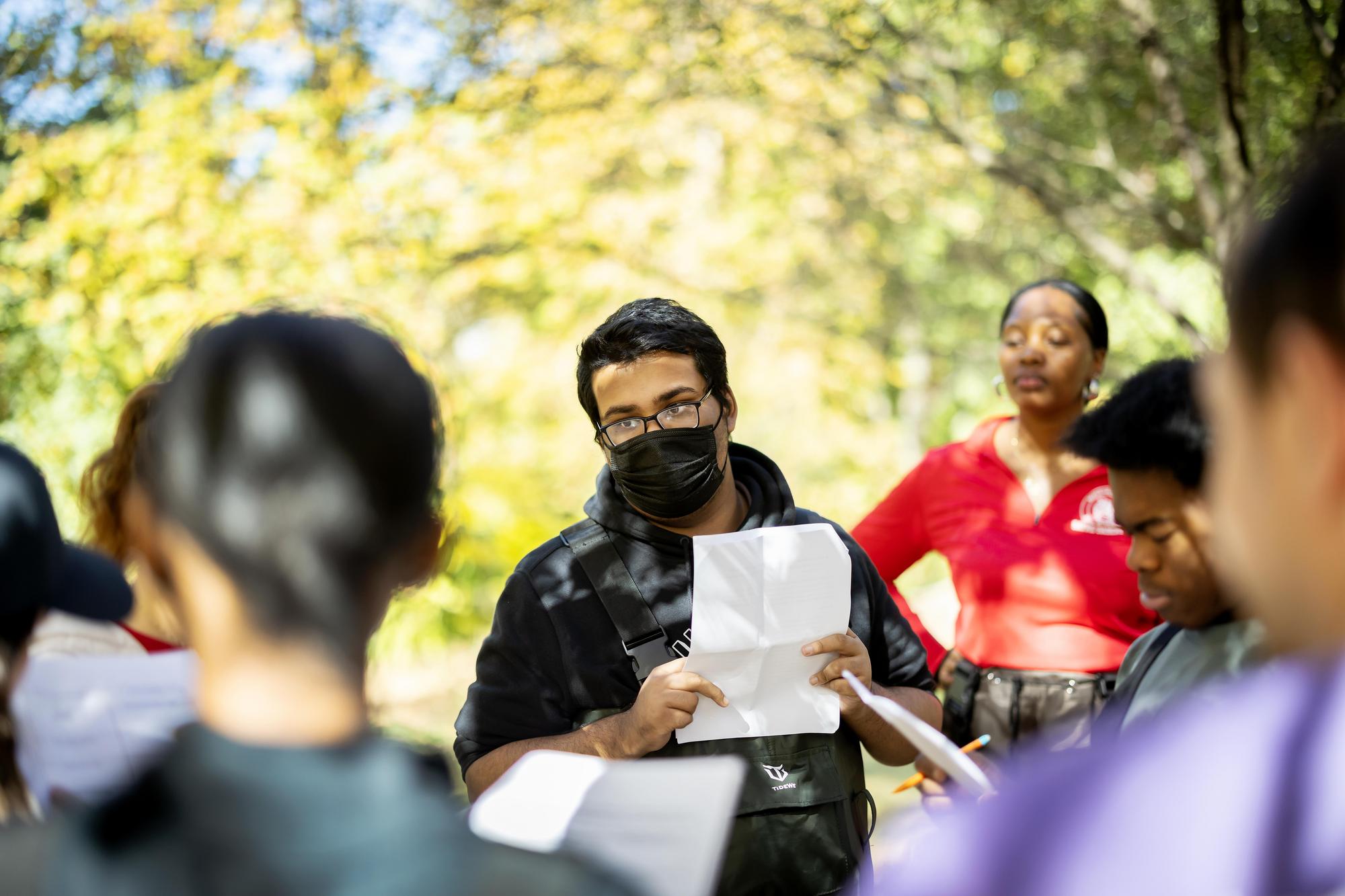 Students standing in a river in Cobb’s Creek.