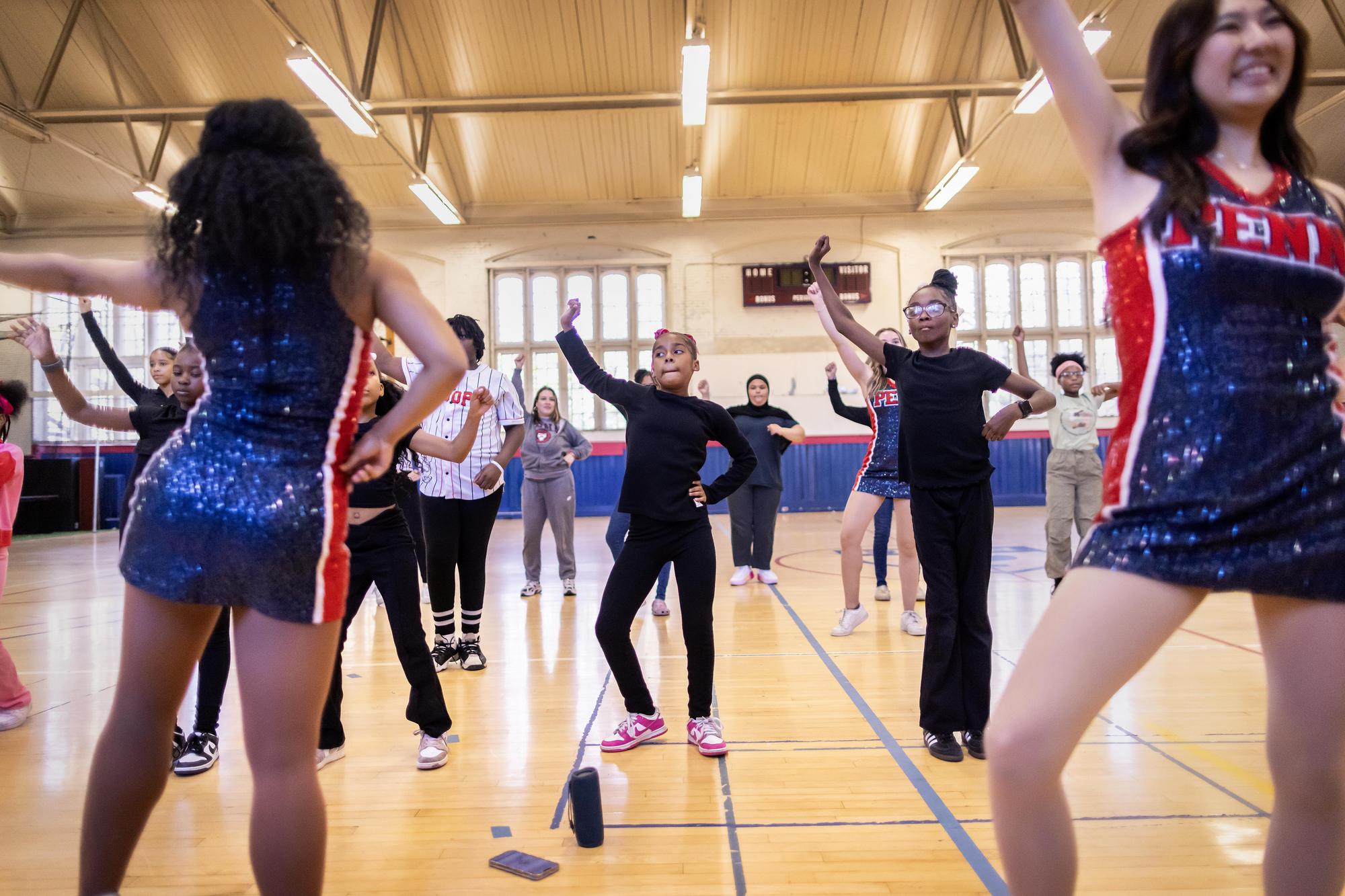 Quaker Girls teach dance choreography to rows of West Philadelphia students