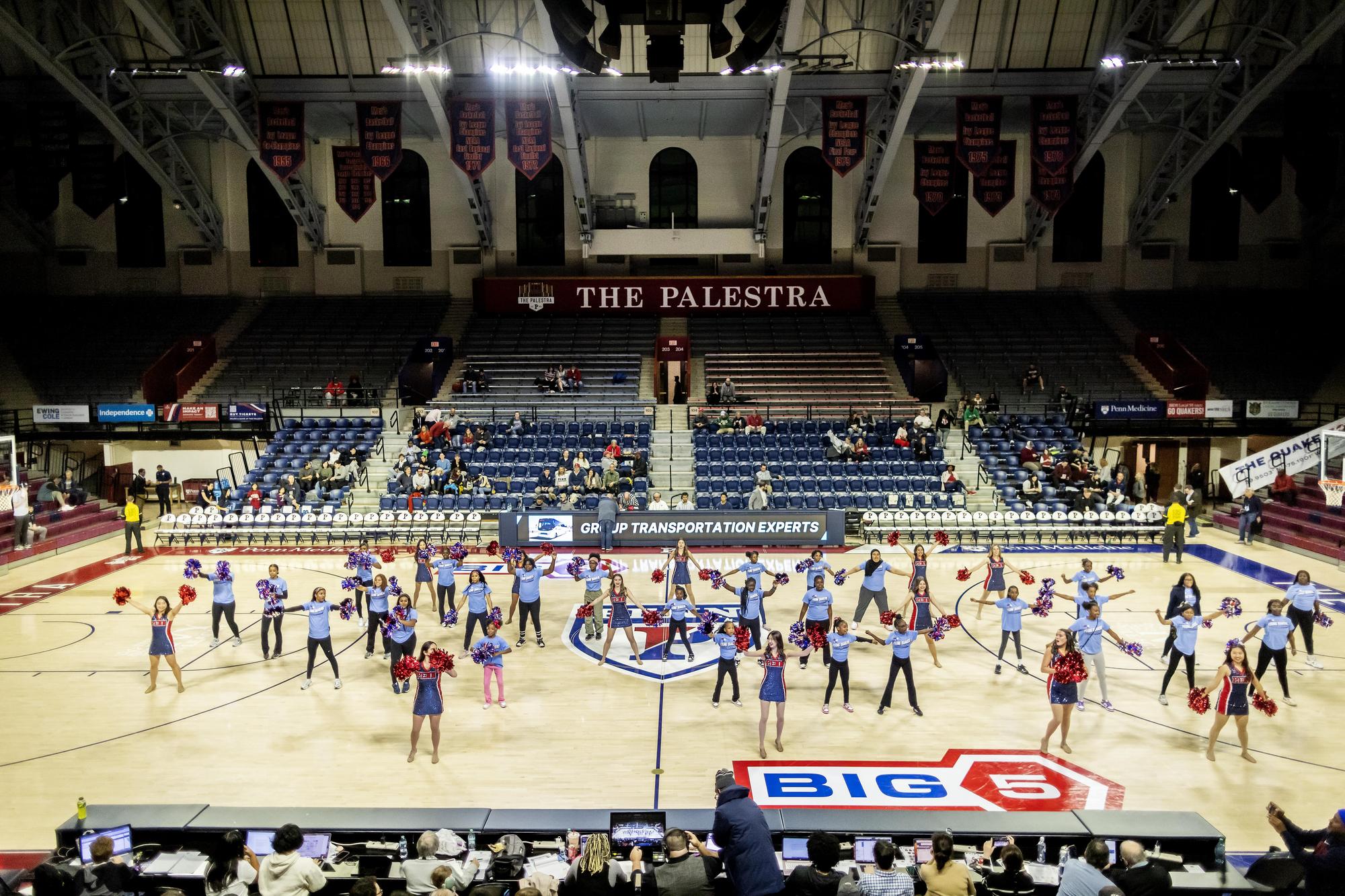 An image of the Palestra, with students dancing on the court. The court says "Big 5" towards the front right