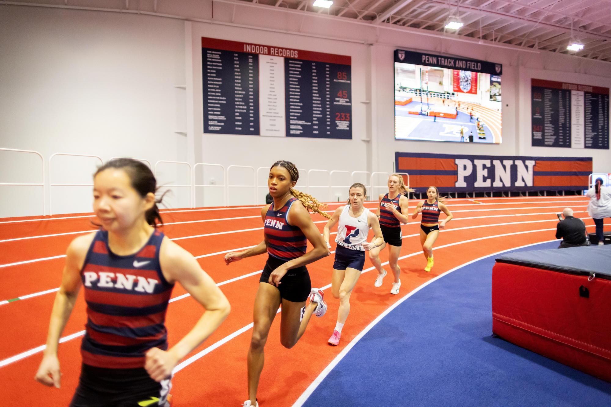 Athletes running on the indoor track.