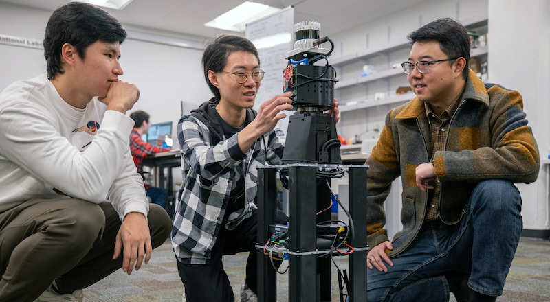 (From left) Freddy Liu, Haowen Lai, and Mingmin Zhao, assistant professor in CIS, setting up a robot equipped with PanoRadar for a test run.