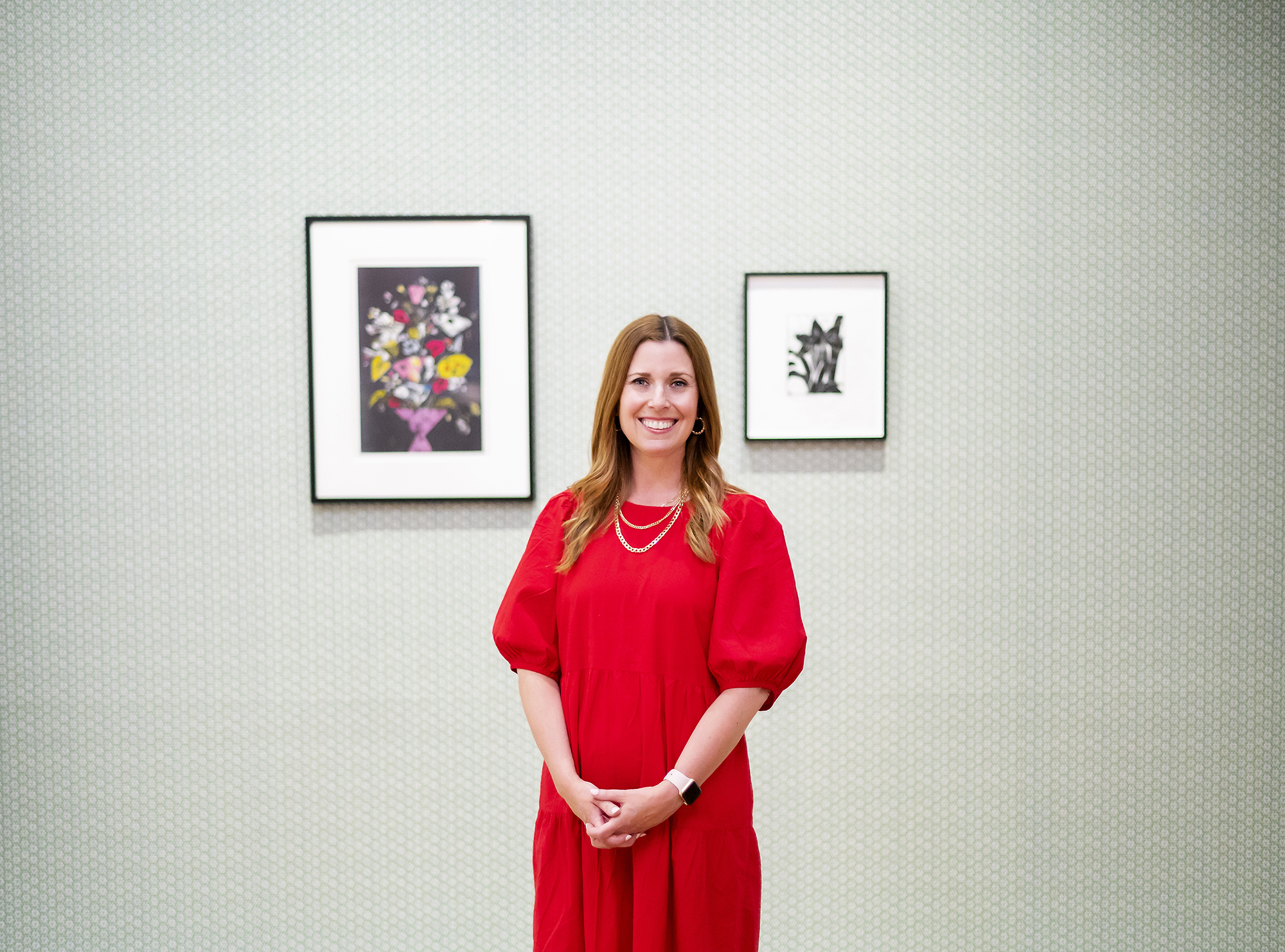 Lynn Dolby standing in front of two artworks