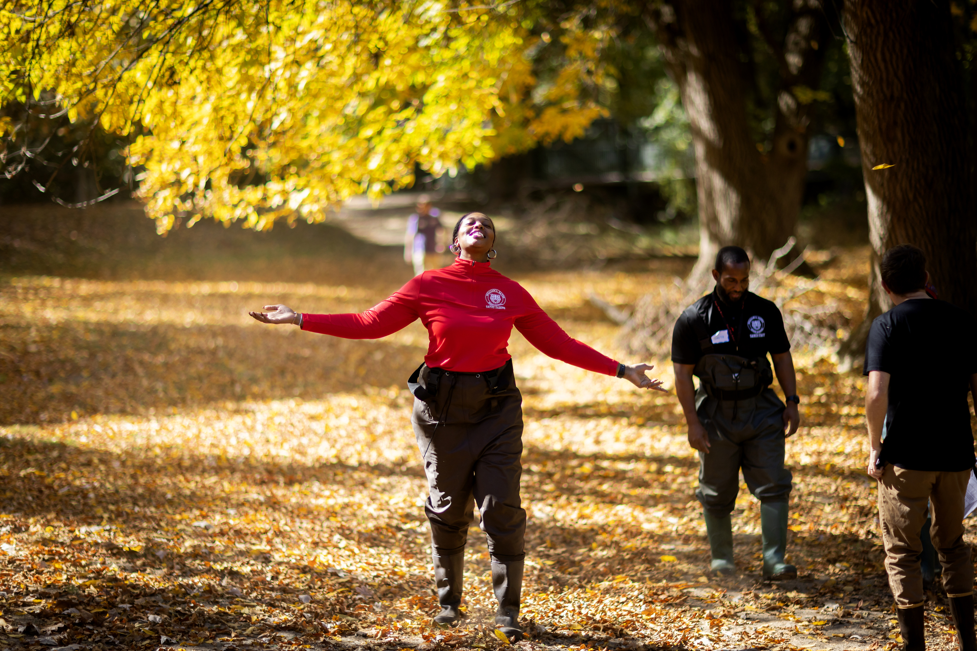 sayre student with arms up enjoying nature