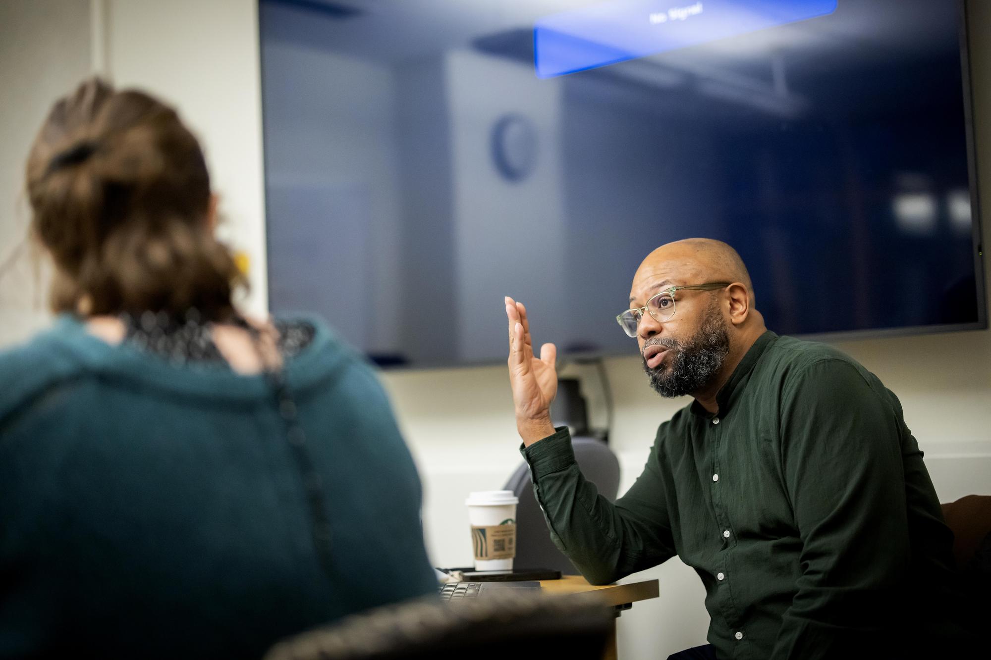 Desmond Patton talks with a student during his Joy class.