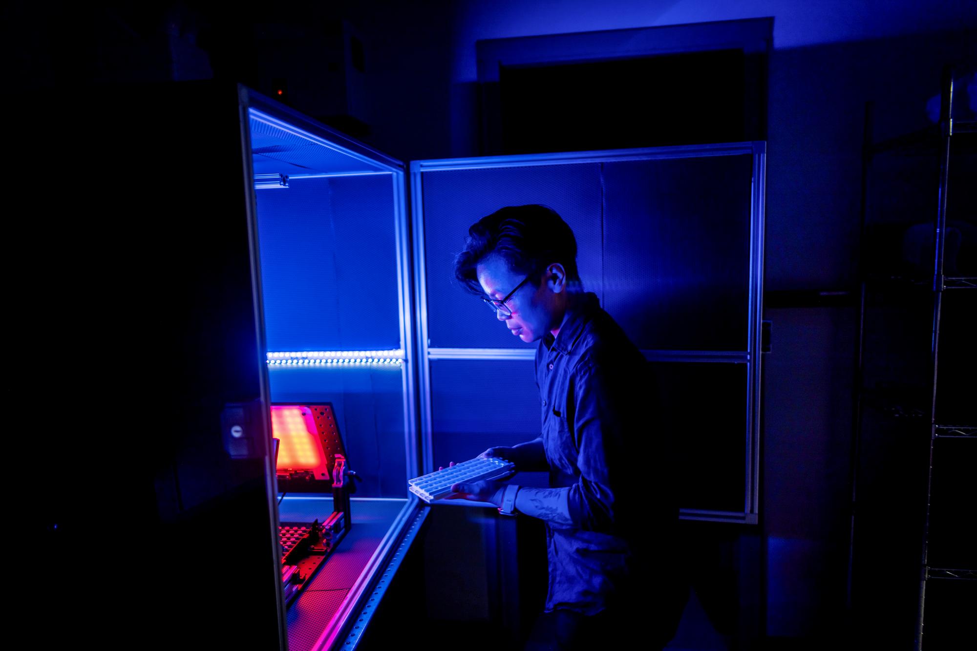 A student conducting light-sensitive research in a lab at Penn.