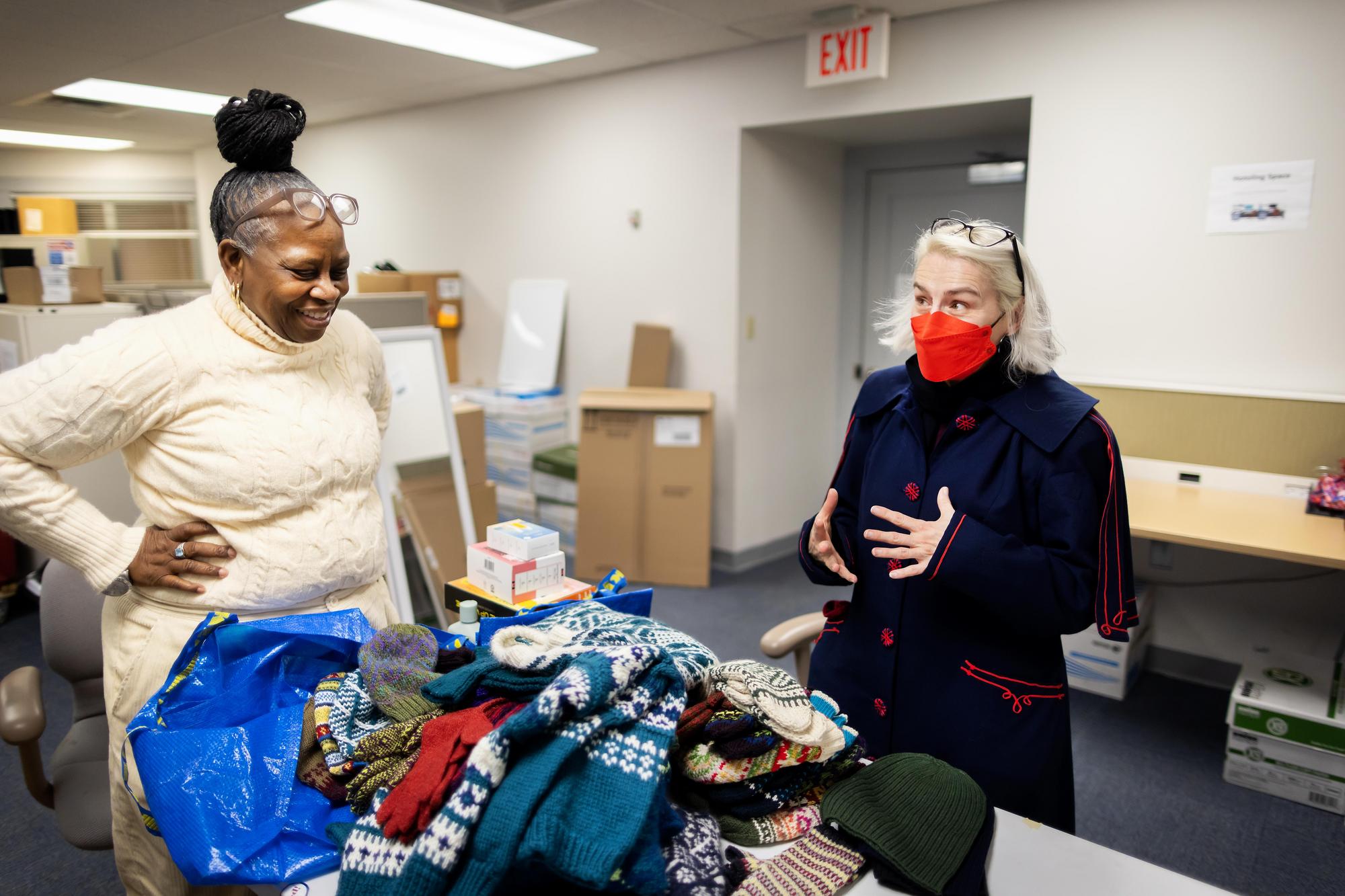 Mary Kinney dropping off knitwear for donation.