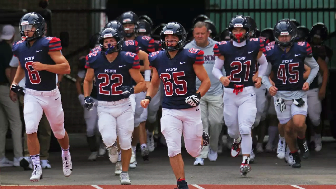 Sprint football players run onto the field.