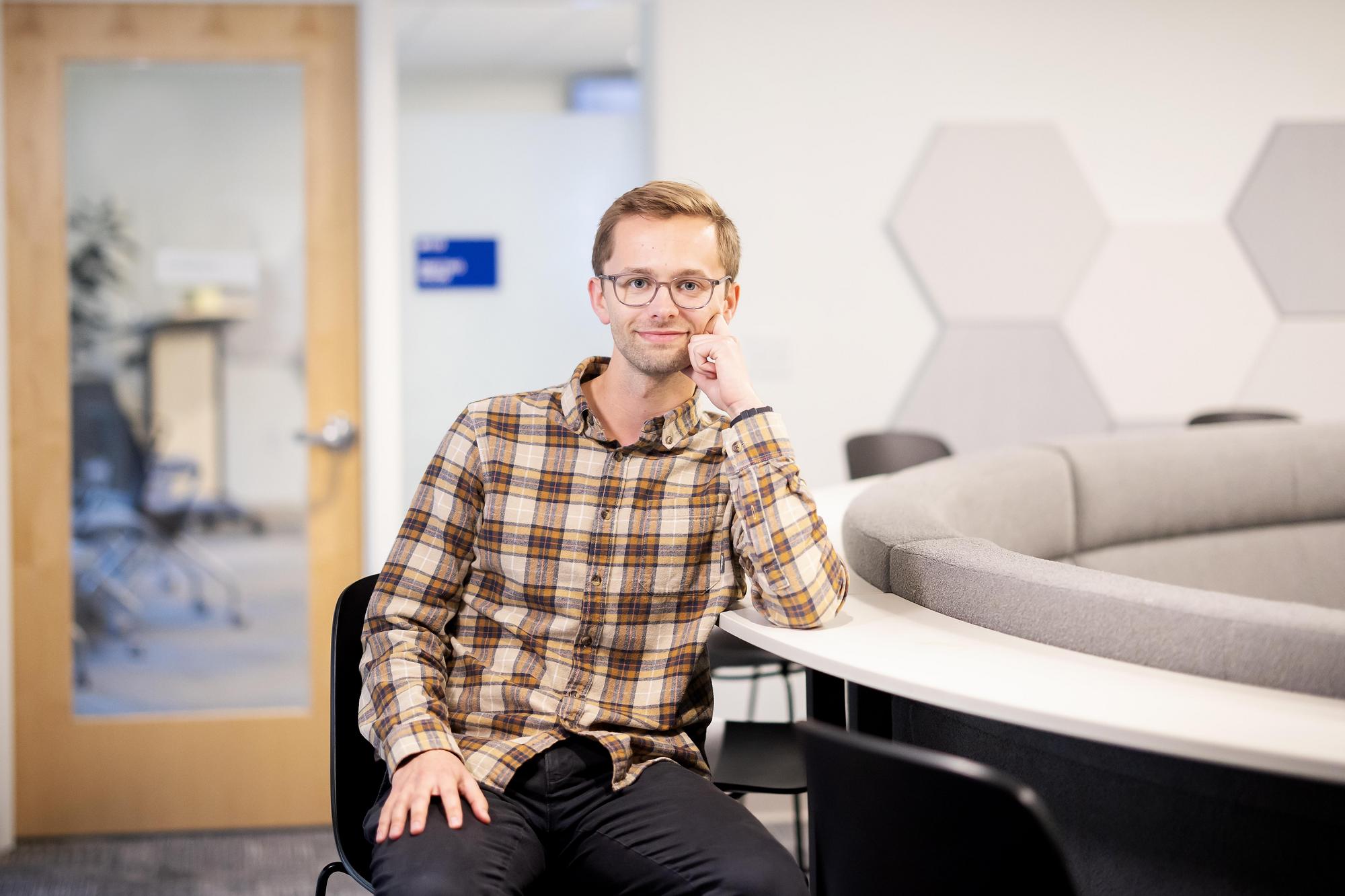 David Clark sits at a curved desk at Wellness at Penn