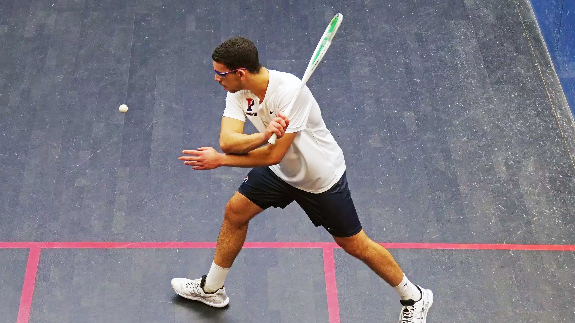 Salman Khalil swings his racquet during a match.