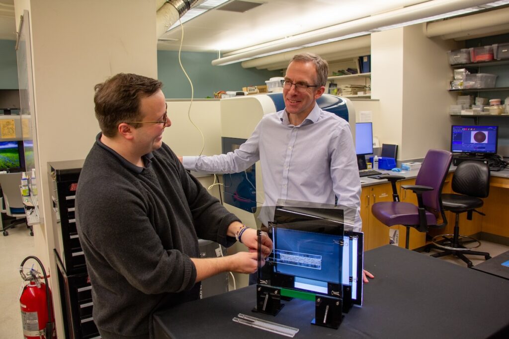 Sage Fulco (right) and Kevin Turner (left) in a lab.