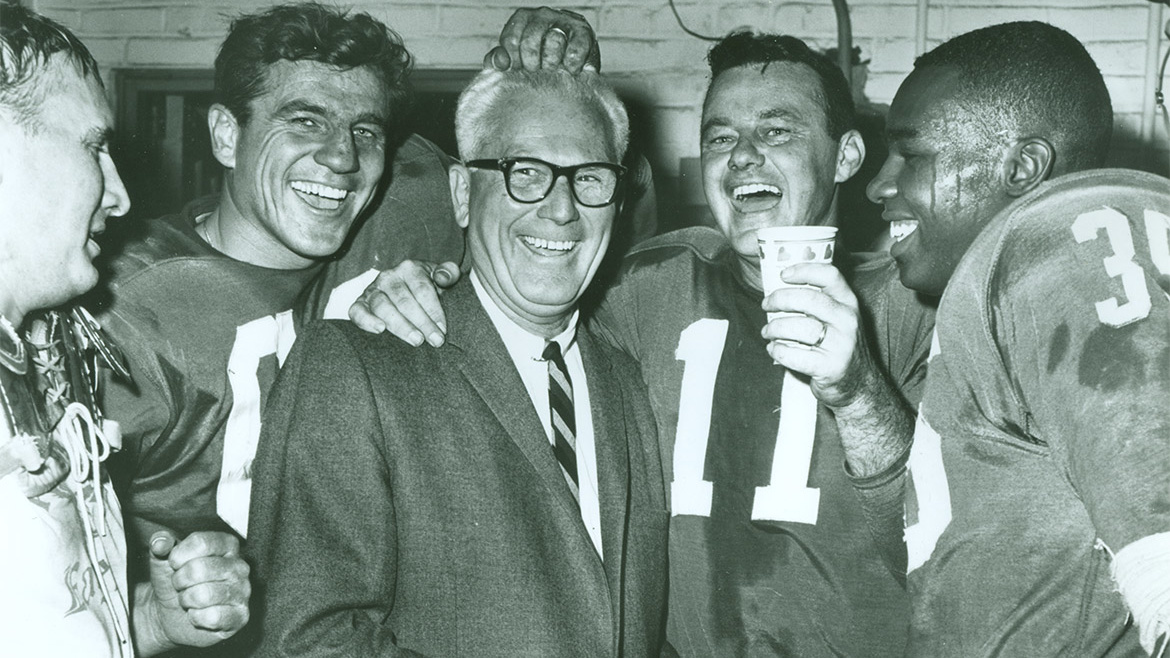 Eagles center, linebacker, and long snapper Chuck Bednarik, second from left, celebrates with Coach Buck Shaw, Van Brocklin, and teammates after the game. Bednarik, a Penn alum, played almost the entire game on offense and defense. 