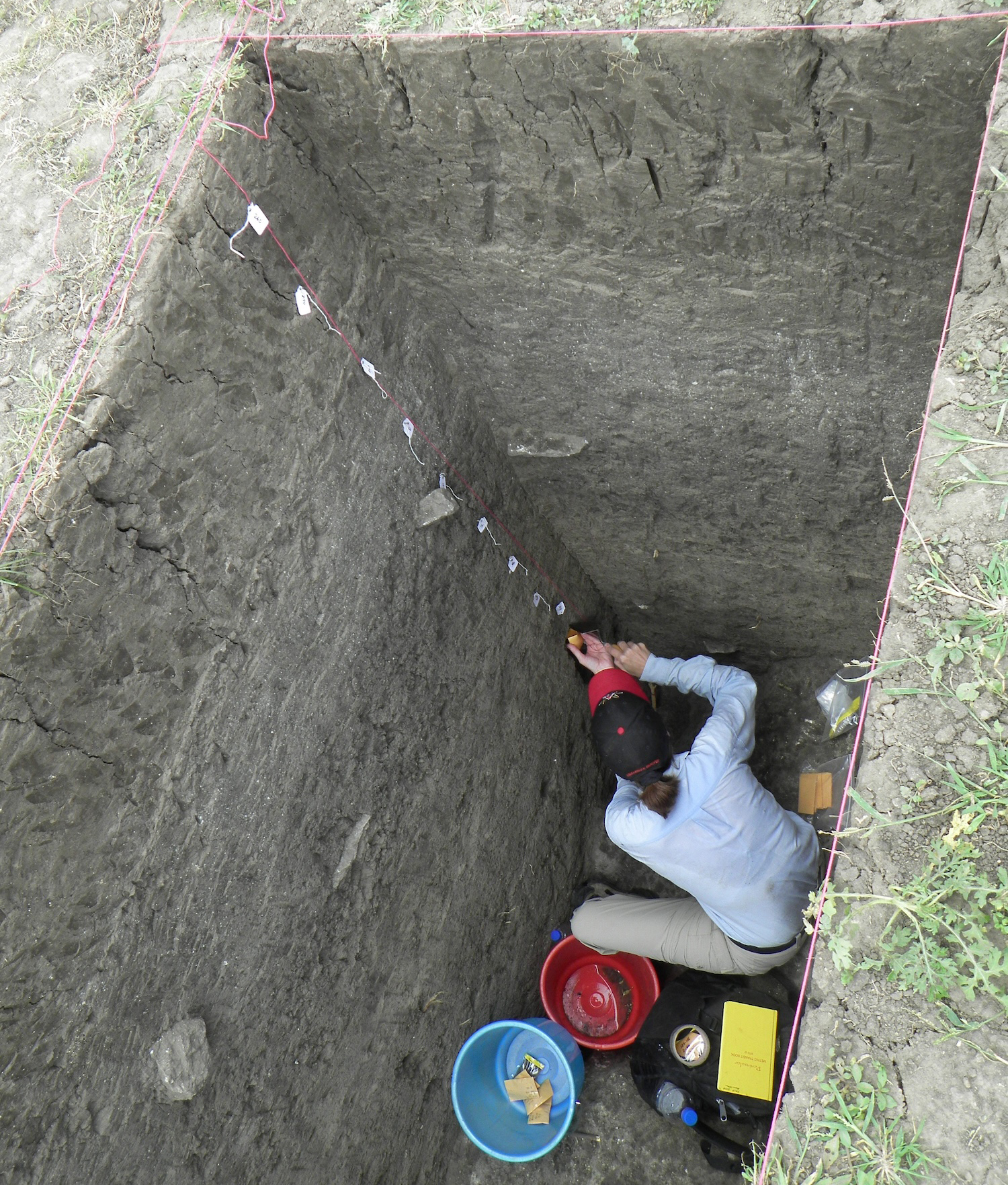 Kathleen Morrison takes sediment samples at archaeological site.