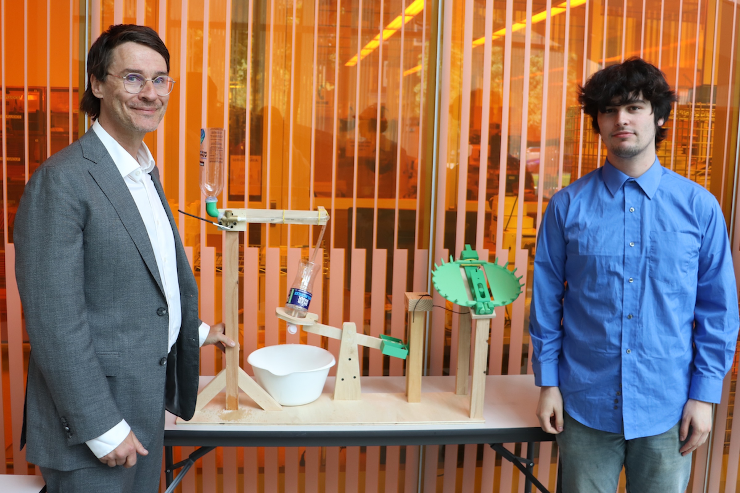 Max Lawrence and his teaching assistant Ryan McCarthy stand next to  a working model of a Venus flytrap.