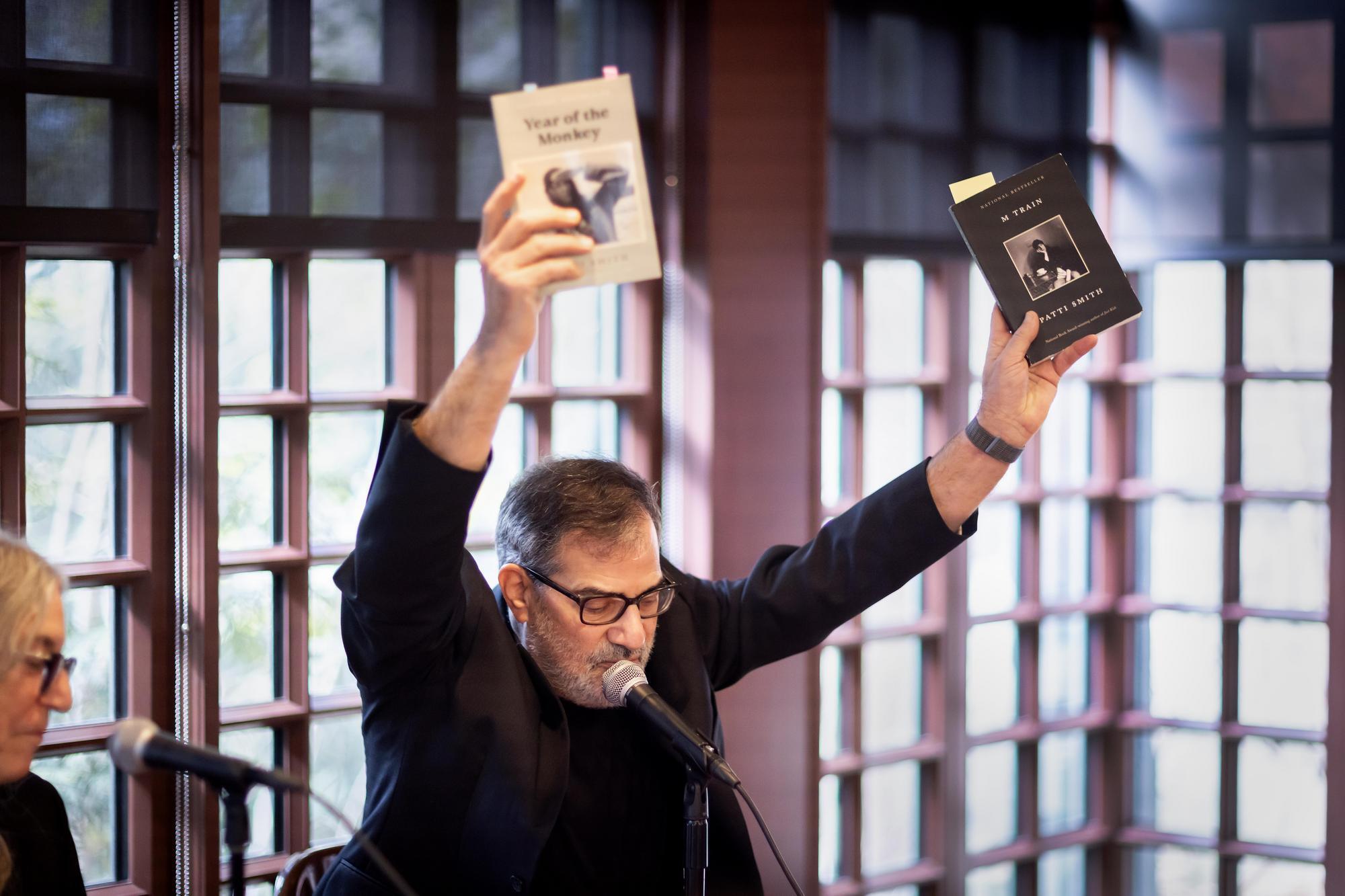 Al Filreis holding two books in the air 