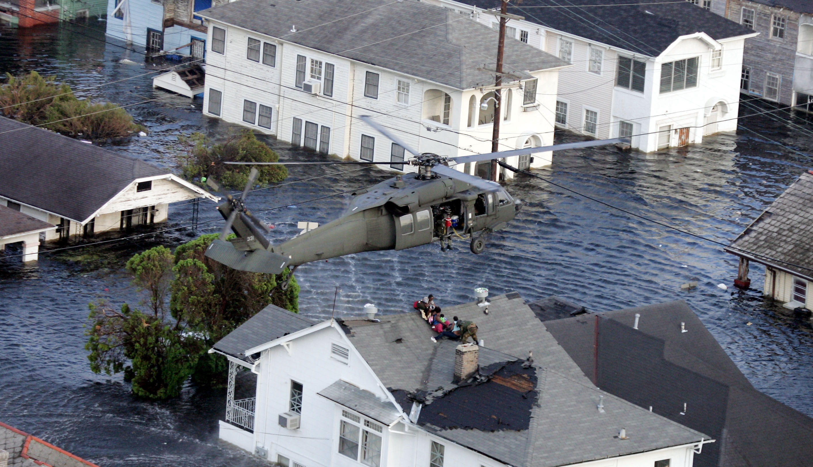 Helicopter rescues residents from roofropts duringthe floods from Hurricane Katrina.