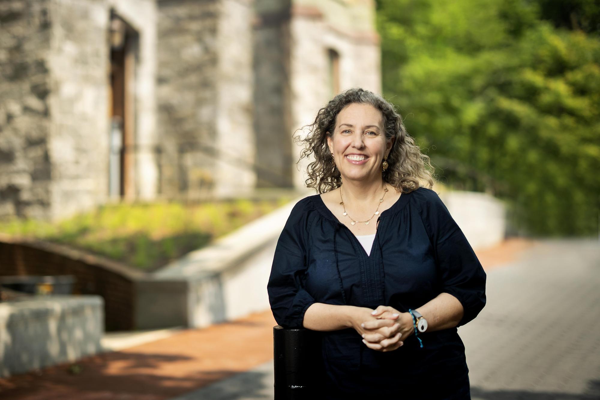 Ann Vernon-Grey standing outside College Hall.