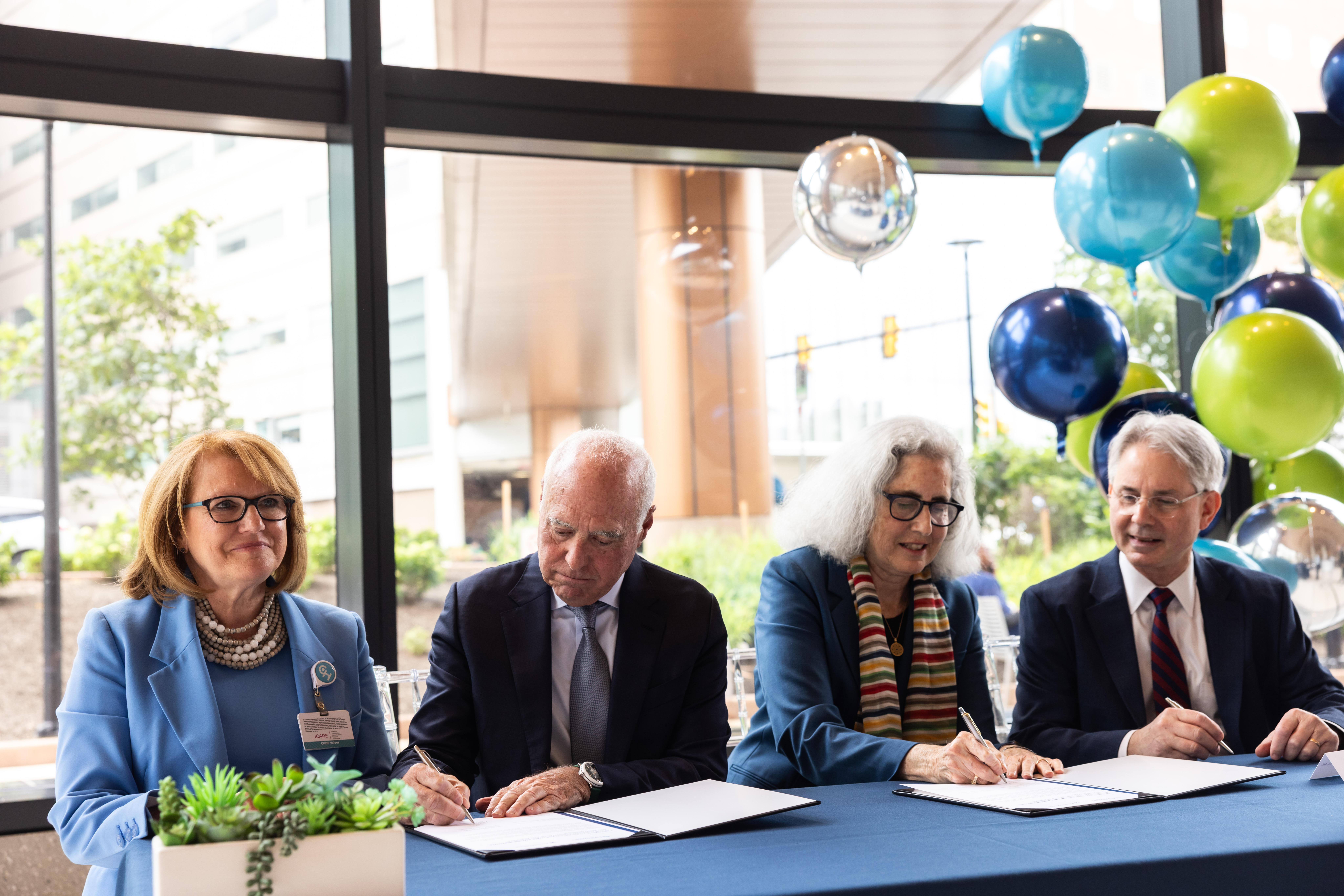 Seated at a table, Madeline Bell, CEO of CHOP; Jeffrey Lurie, CEO and chairman of the Philadelphia Eagles; Cathy Lurie, president of the Nancy Lurie Marks Foundation; and Jonathan A. Epstein, dean of the Perelman School of Medicine and Executive Vice President of the University of Pennsylvania for the Health System