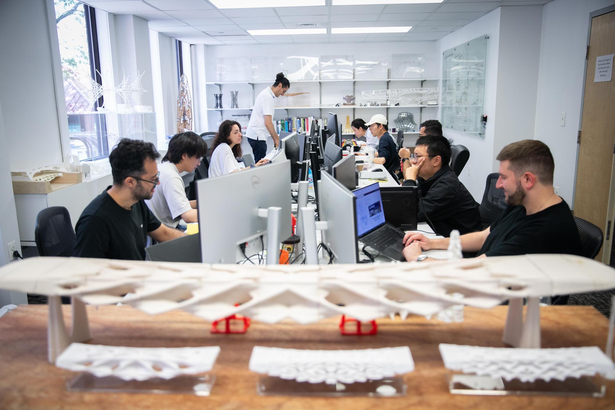 Several people seated at computers in a lab.