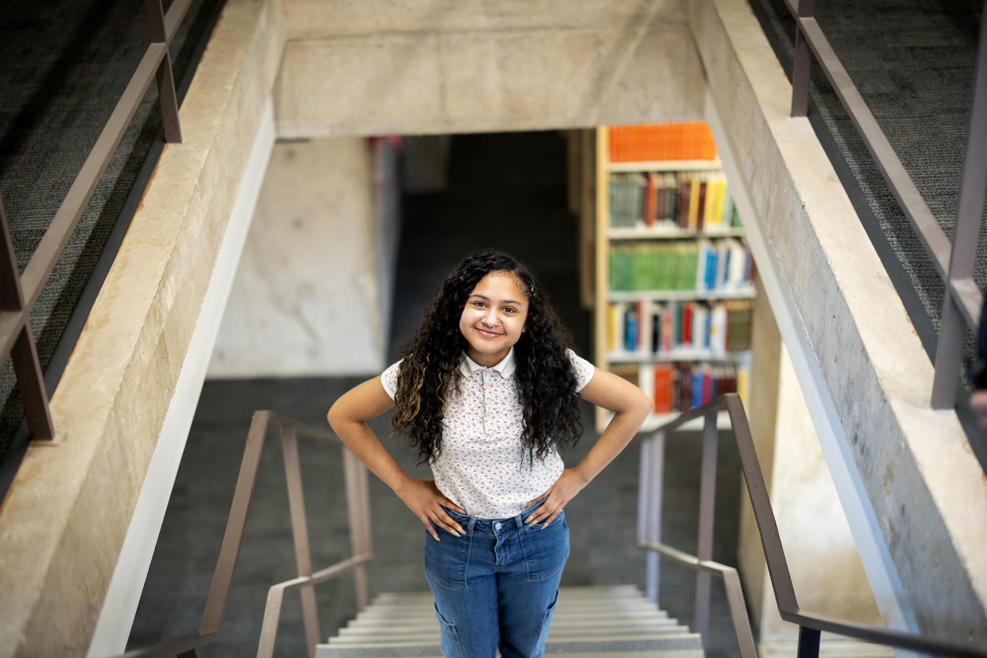 Sierra Williams standing in a library stairwell.