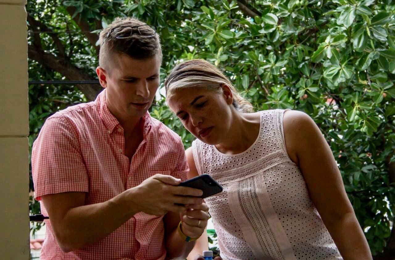 Penn-in-Cuba-Will-Schmenner-and-art-history-professor-Gwendolyn-DuBois-Shaw-look-at-artwork-images-on-phone.