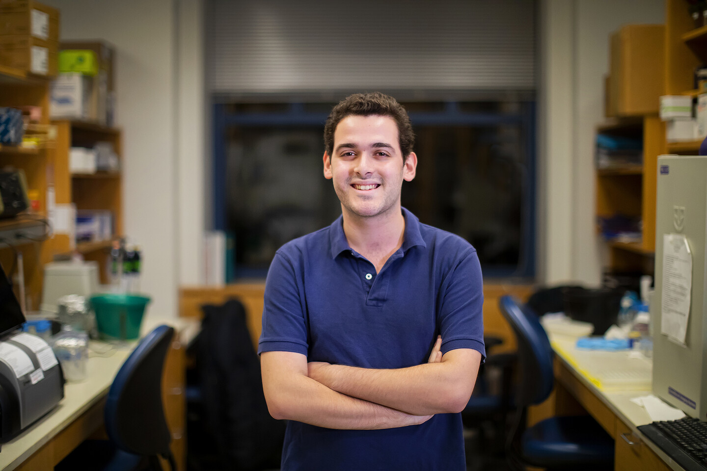 Penn senior Andrew Ravaschiere standing in a lab surrounded by equipment
