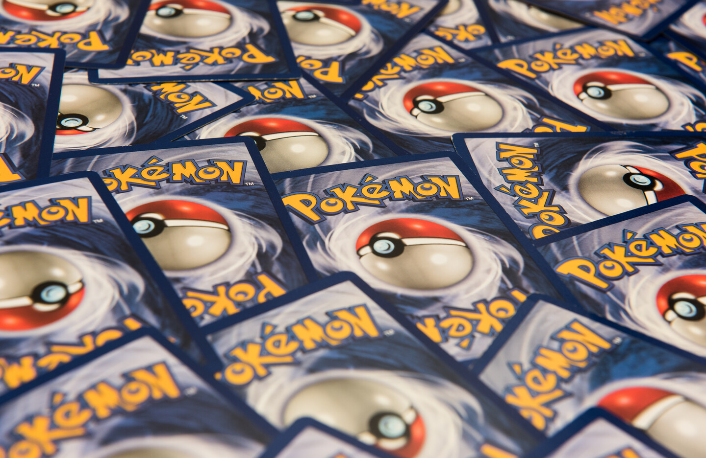 Trading cards with the word Pokemon and the game's red and white ball symbol on a blue background.