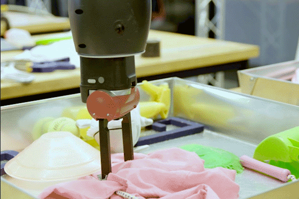 GRASP lab machine with two vertical parts appearing to reach down and grab an object in a tray