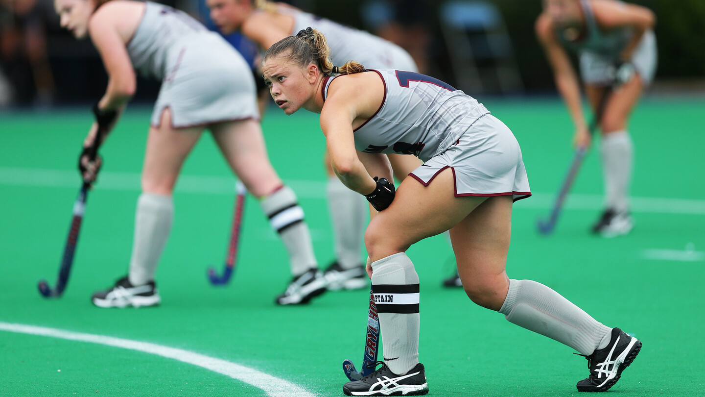 Alexa Schneck of the field hockey team on the field holding a stick during a game.