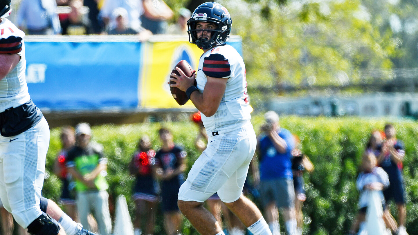 Nick Robinson, a quarterback on the football team, drops back and prepares to throw.