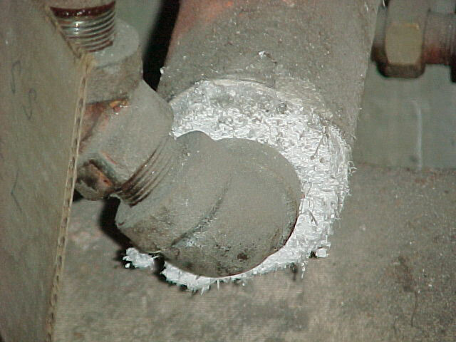 the end of a pipe with fuzzy asbestos fibers wrapped around it