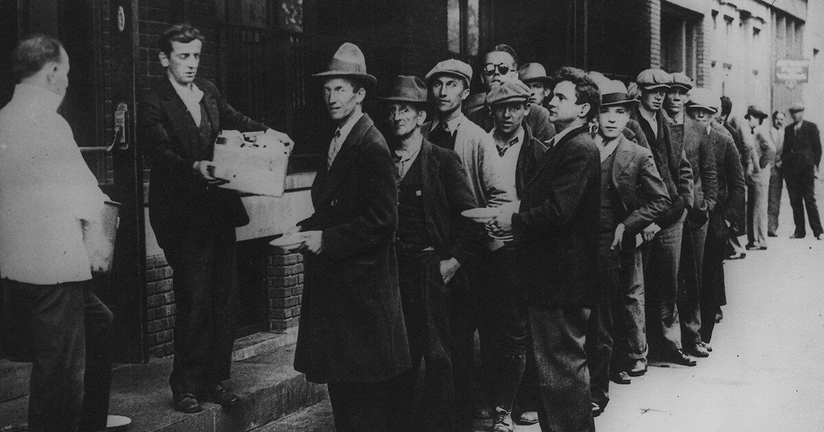 A long line of people waiting to in a bread line in New York City during the Great Depression in 1932