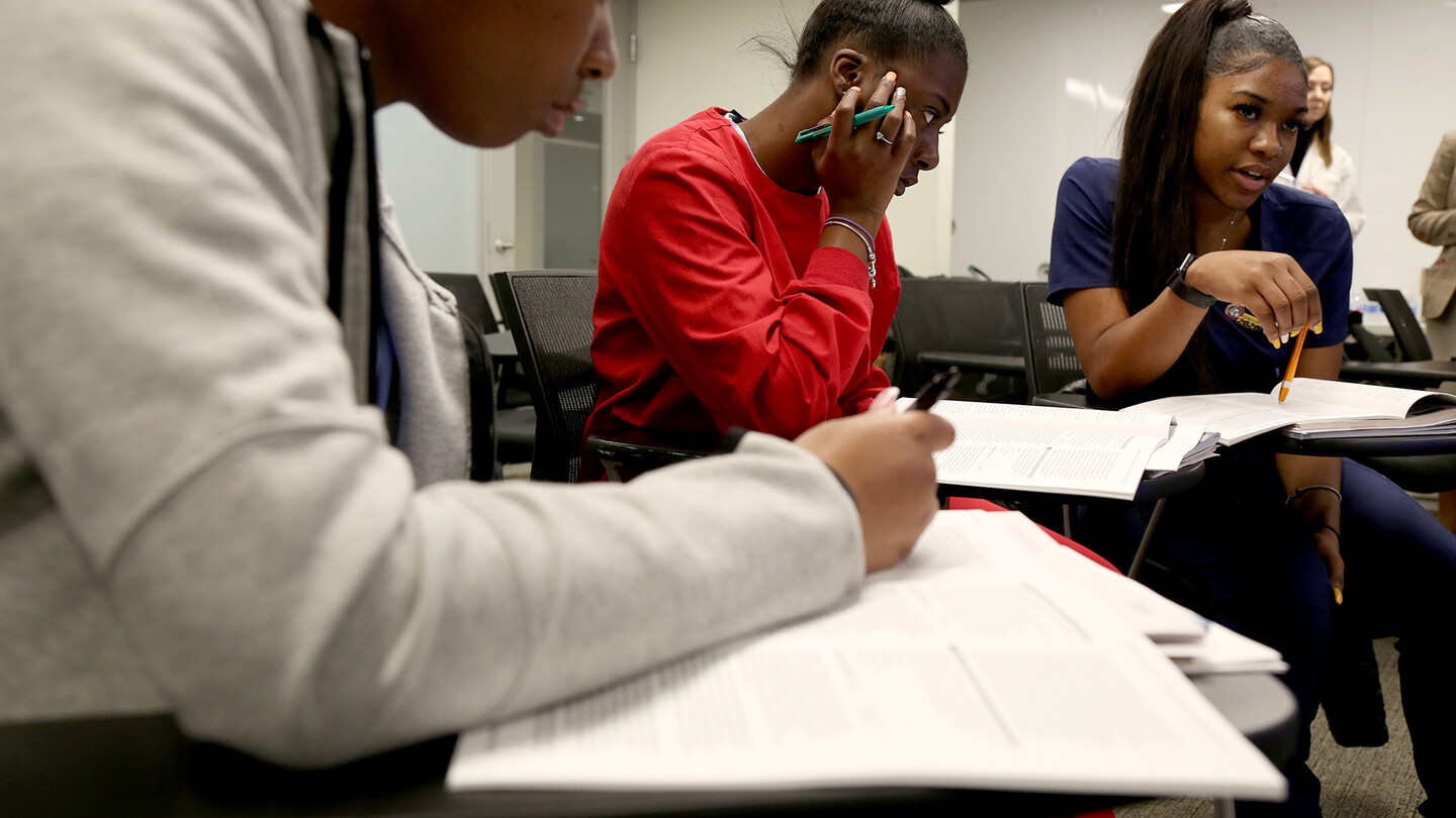 dental students in a classroom writing