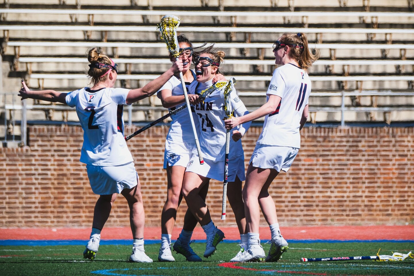 three players surround Rosenzweig to celebrate