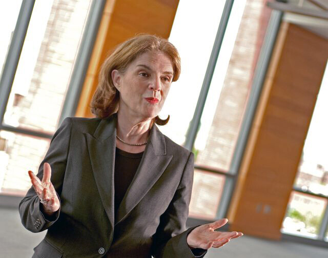 Susan Wachter stands in front of sunlit windows 