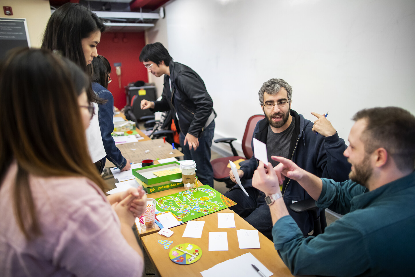Students gather around board games