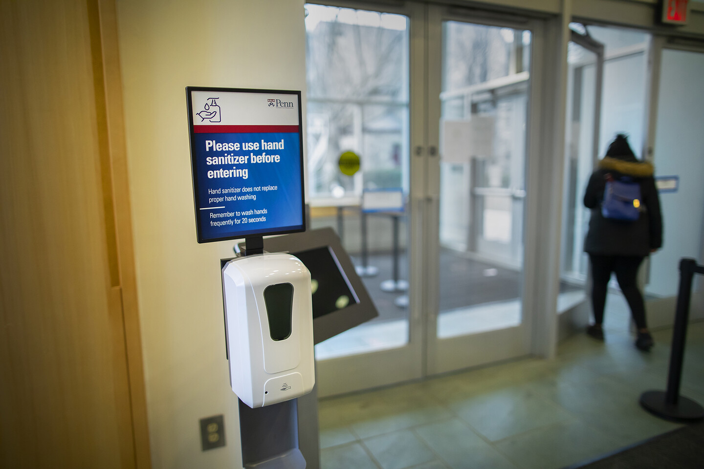 A hand sanitizing station that says Please use Hand sanitizer before entering