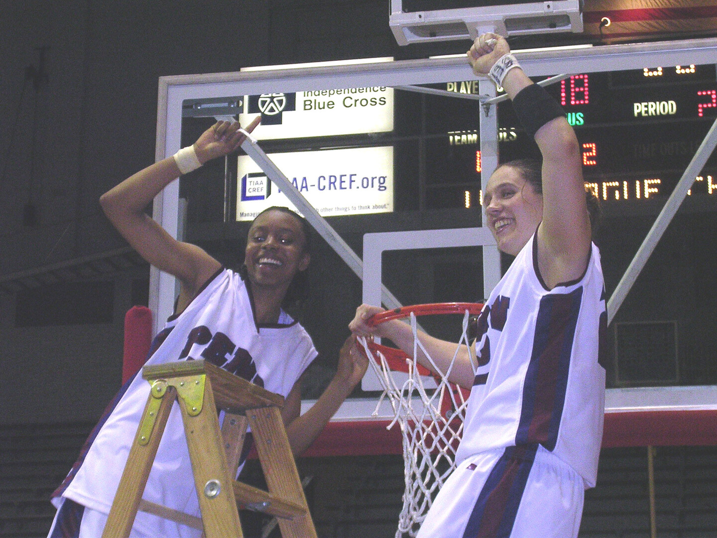 Jewel Clark and Mikaelyn Austin cut down the net after winning the Ivy League title at the Palestra.