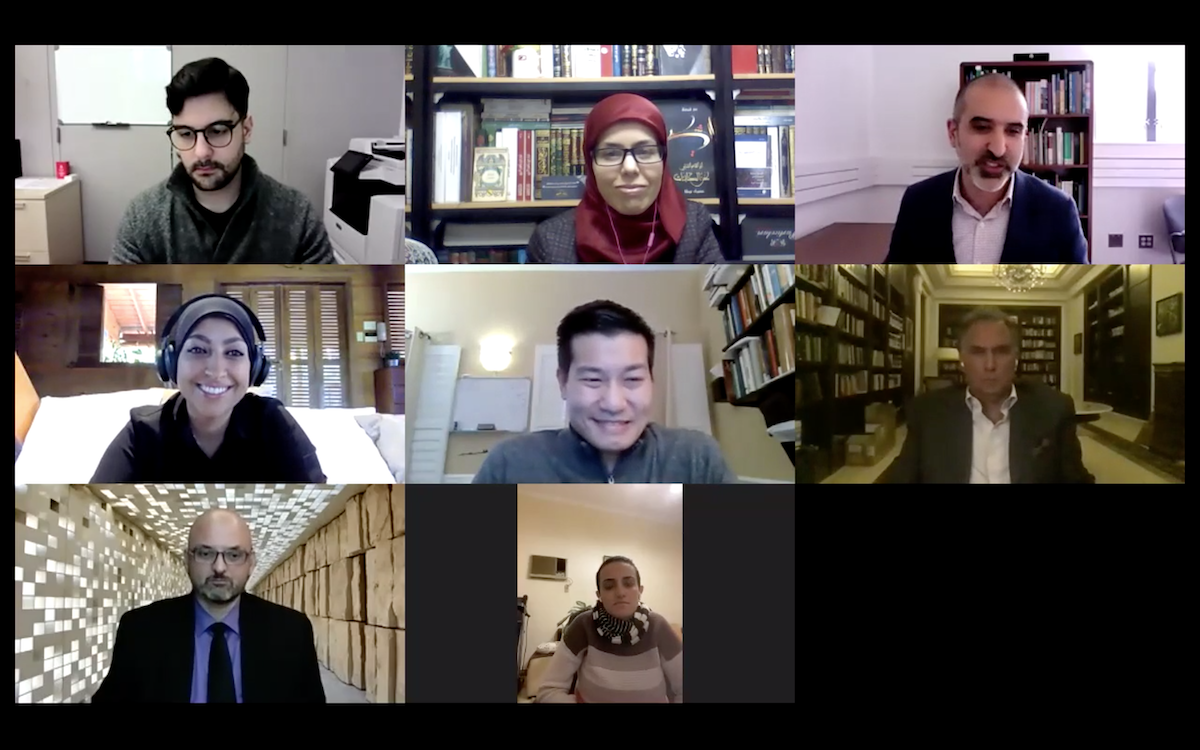 Eight people appear in boxes on a computer screen in a Zoom call