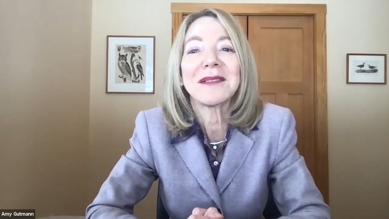 Woman with blond hair and light purple suit looks into the camera