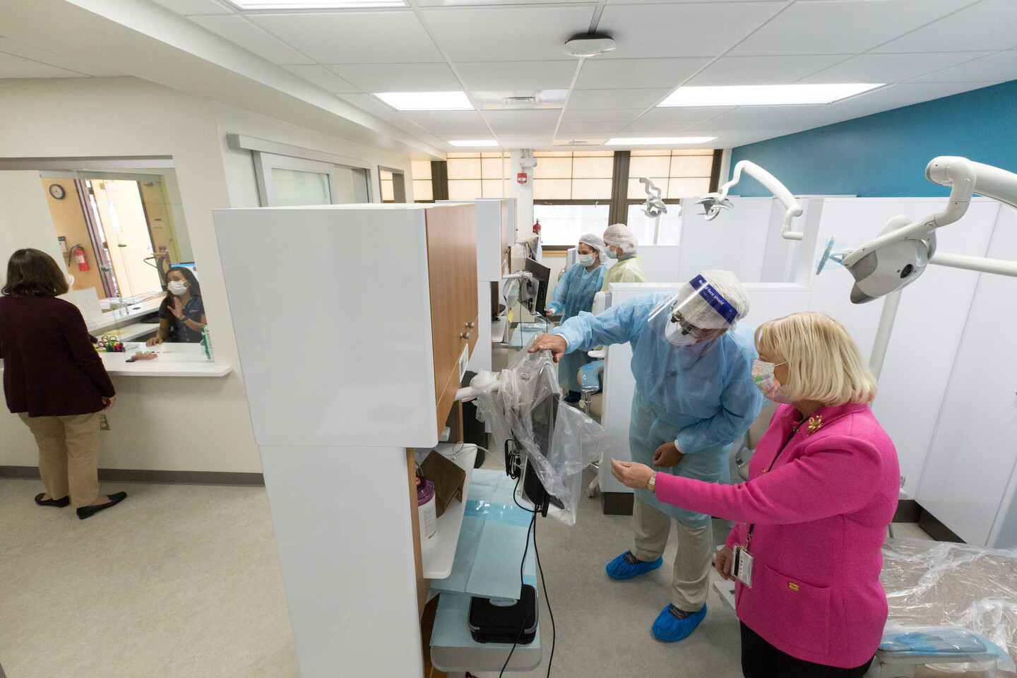 View of workers and a patient in a dental clinic