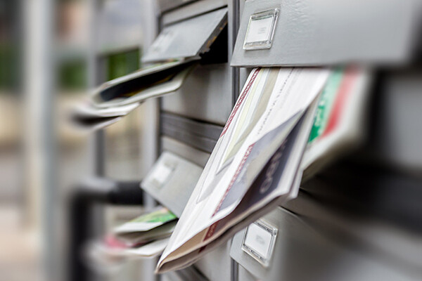 Grey mail slots are full of letters and other post