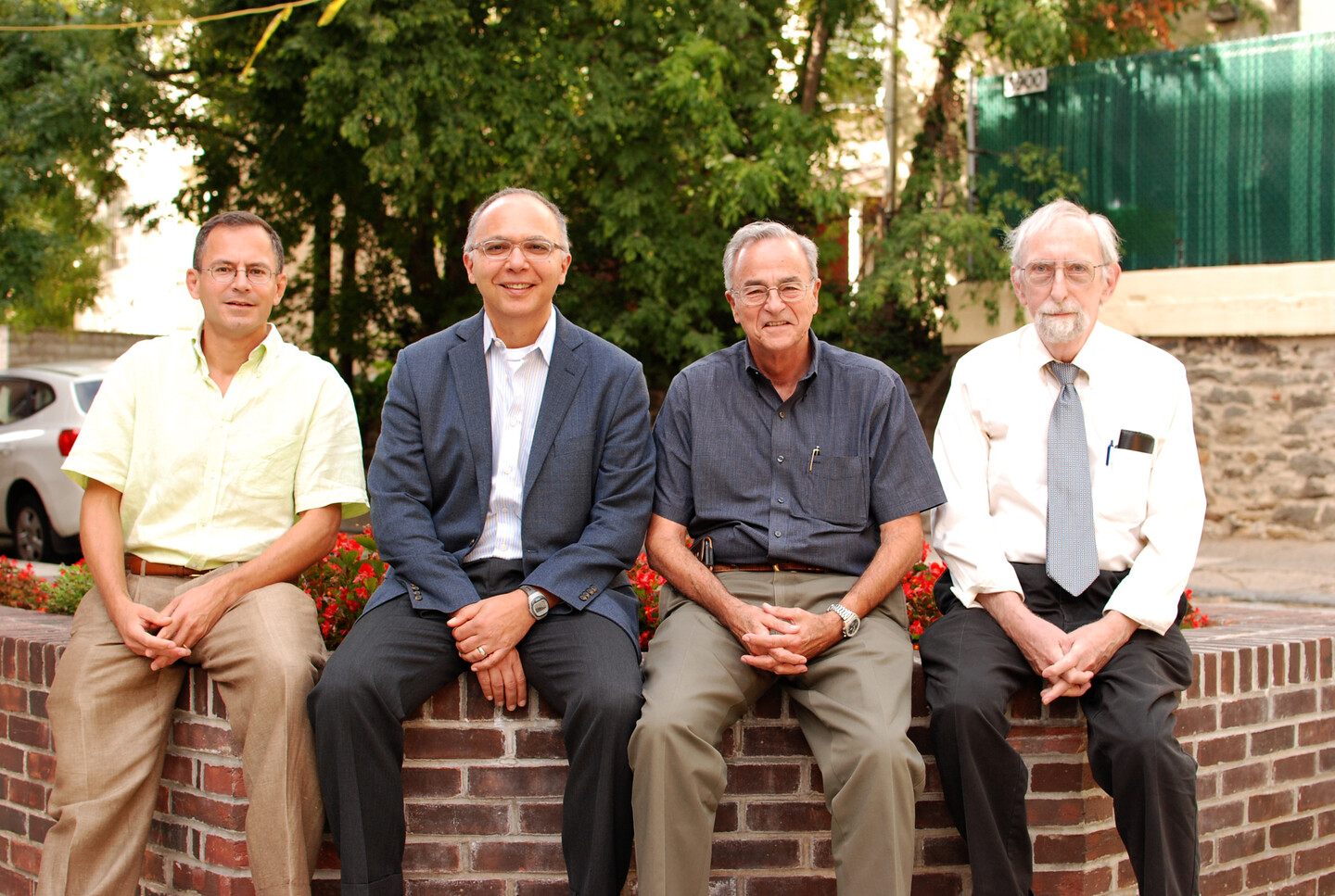 Four researchers seated on a bench outside
