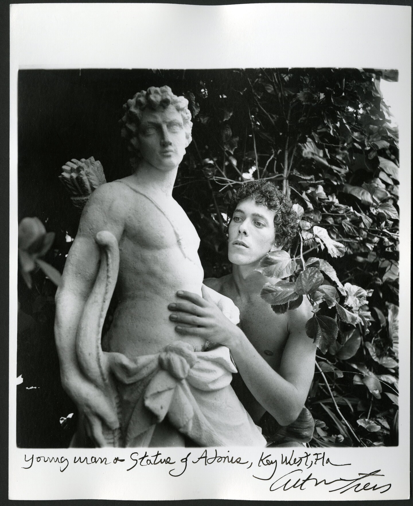 Person with statue in garden 